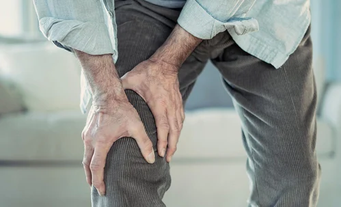 A man holding his knee